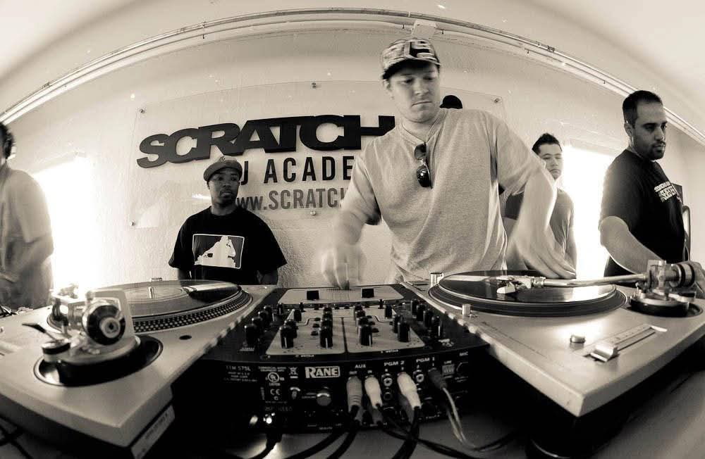 DJ Real performing with turntables and controller